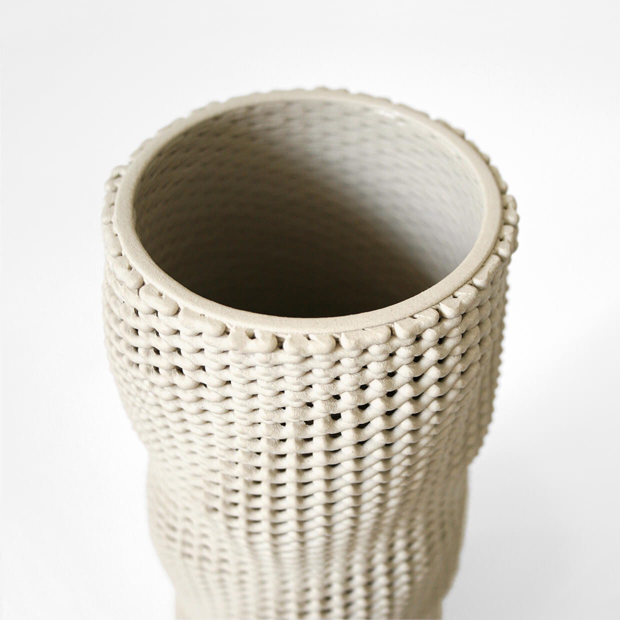 
                  
                    Close-up of Kilim a 3D printed ceramic vase by Drag And Drop on a white background
                  
                