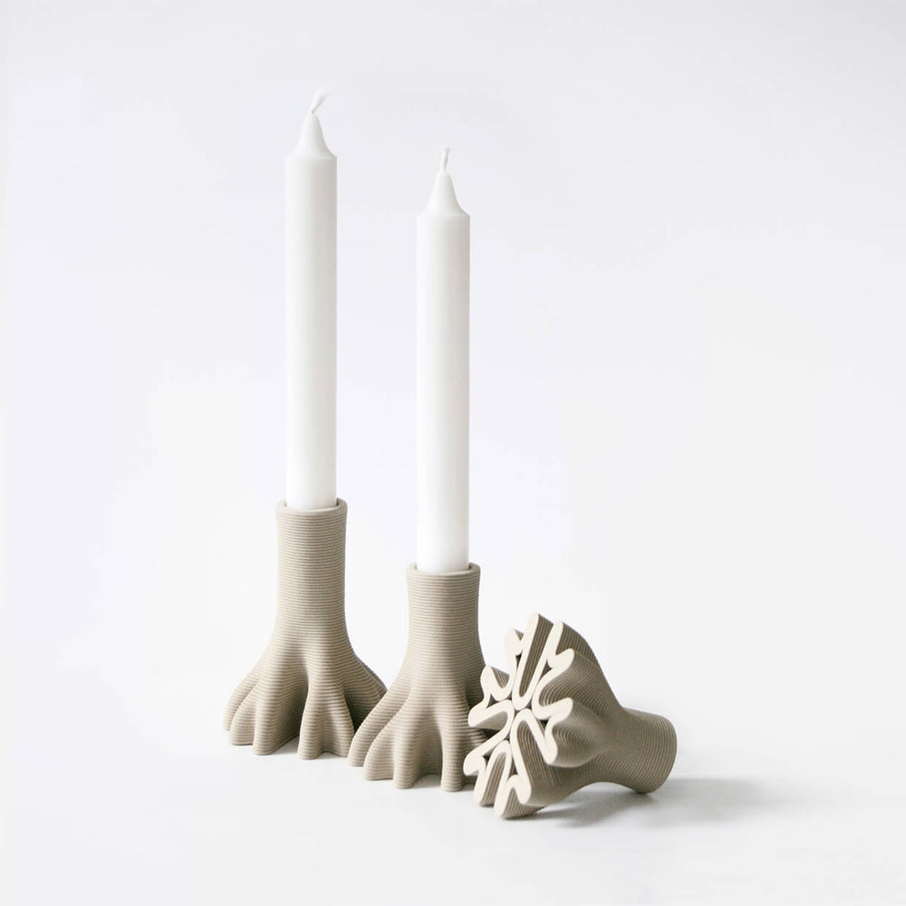 
                  
                    Set of 3 3D Printed Ceramic Candleholders holding candles. One of them is upside down to show the spectacular base
                  
                