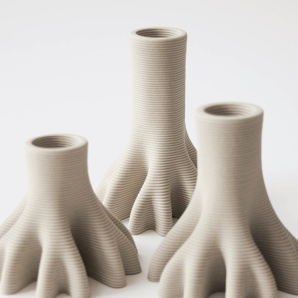 
                  
                    Closeup of a set of 3 3D Printed Ceramic Candleholders 
                  
                