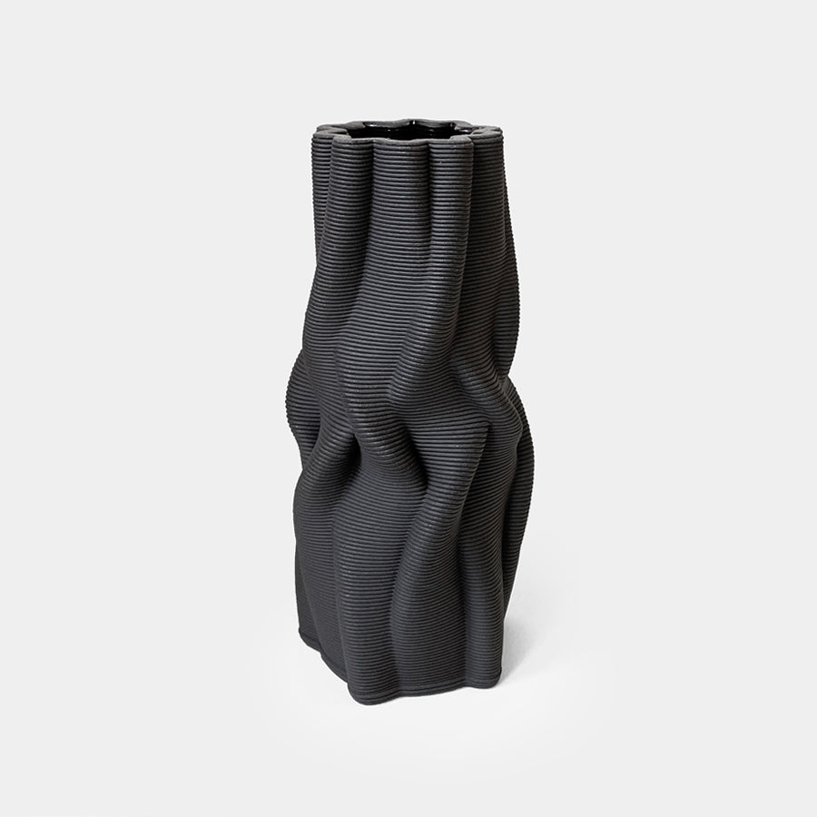 The use of 3D printing minimizes material waste, while the choice of natural clay and the hand-finishing procedure further emphasize it's environmentally-conscious nature.