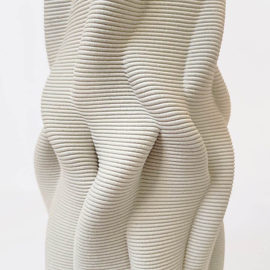 The award-winning Intertwined vase is inspired by the mesmerizing fluidity of growth patterns found in plant roots and tree trunks. It is 3d printed out of natural clay