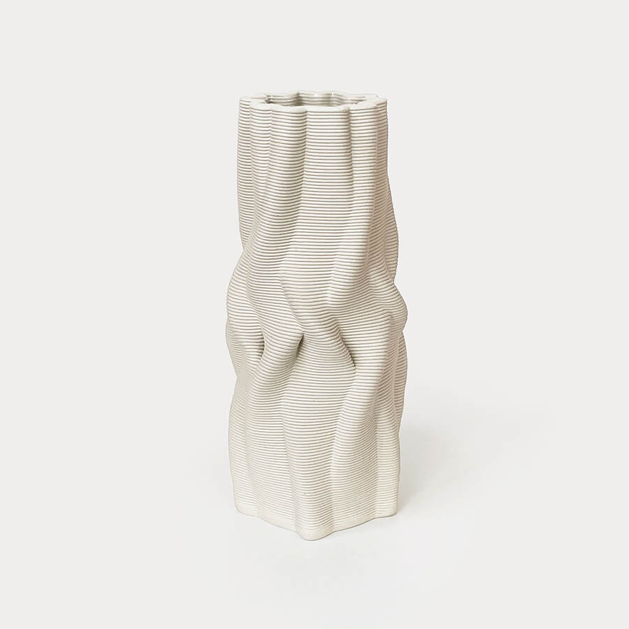 The use of 3D printing minimizes material waste, while the choice of natural clay and the hand-finishing procedure further emphasize it's environmentally-conscious nature.