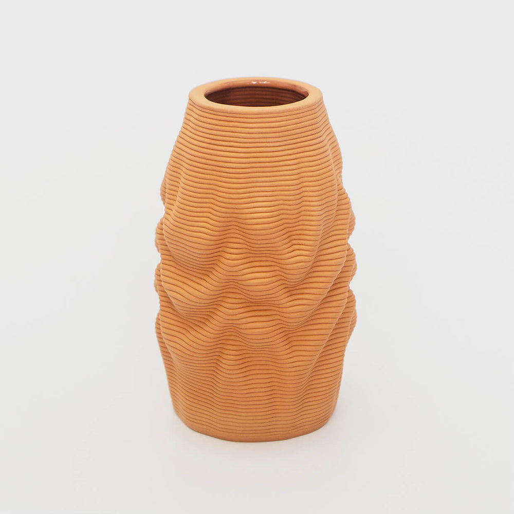 The tough stoneware body embodies the illusion of a soft, melting object, inviting viewers to contemplate the interplay between solidity and fluidity. The natural clay material exudes a warm and earthy aesthetic, further enhancing its organic appeal.