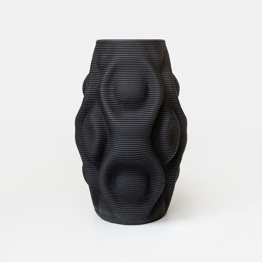 A 3D printed ceramic vase inspired by the concept of ripples and meandering waves would be an elegant and contemporary piece that adds a touch of nature-inspired beauty to any home decor.