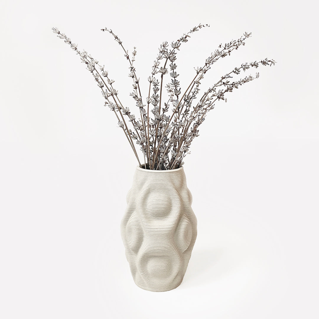 3D printed ceramic vase inspired by the concept of ripples that adds a touch of nature-inspired beauty to your interior design.