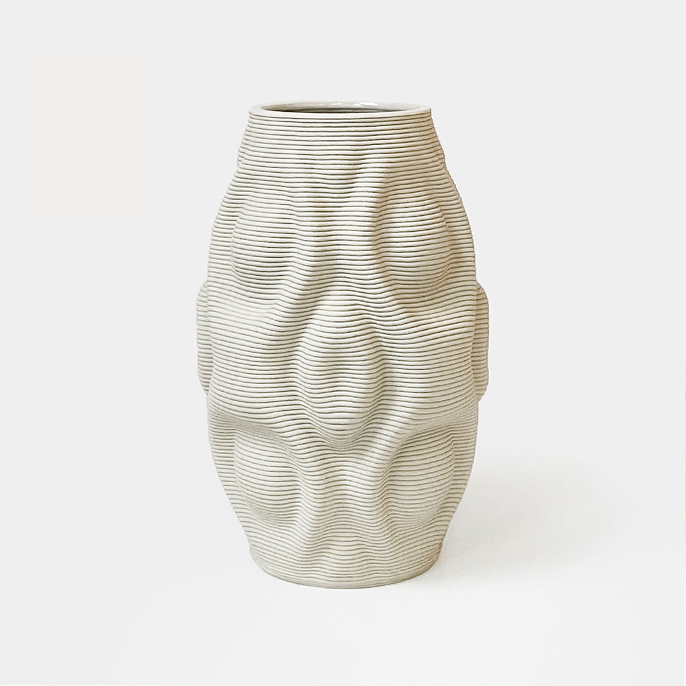 
                  
                    The vase's design features a curvaceous body, mimicking the gentle flow of water. It showcases organic ripples that undulate gracefully, evoking a sense of movement and fluidity. The shape is derived from mathematical formulas, meticulously translated into a 3D printed ceramic vase
                  
                